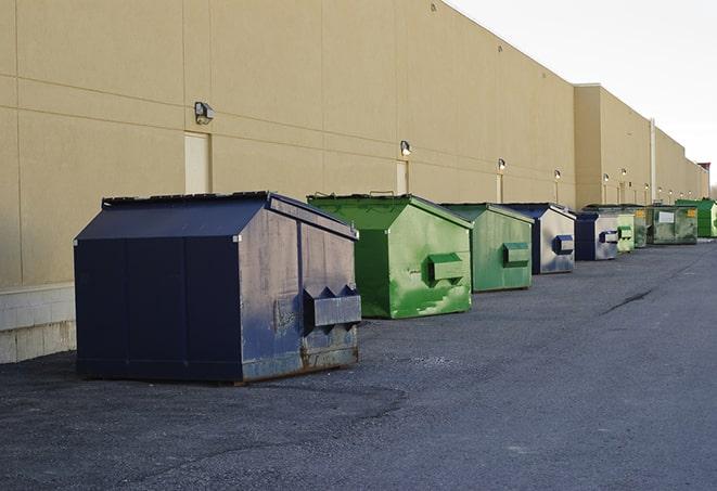 a group of construction workers taking a break near a dumpster in Tioga ND